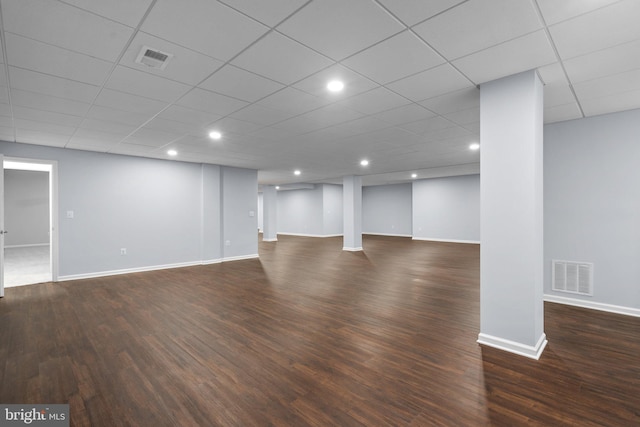 basement with dark hardwood / wood-style flooring