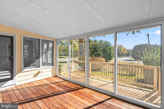 unfurnished sunroom with vaulted ceiling