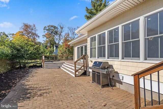 view of patio / terrace featuring a deck and a grill