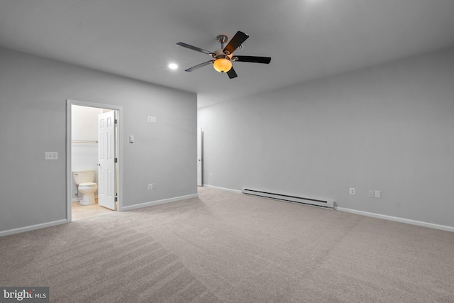 interior space featuring light carpet, a walk in closet, ensuite bath, ceiling fan, and baseboard heating