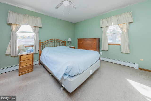 carpeted bedroom featuring baseboard heating and ceiling fan