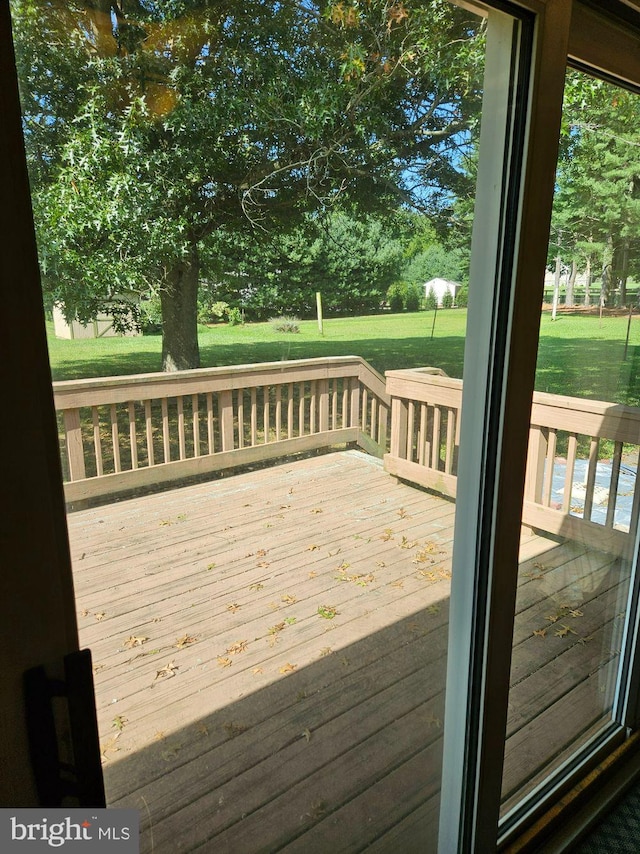 wooden deck with a lawn