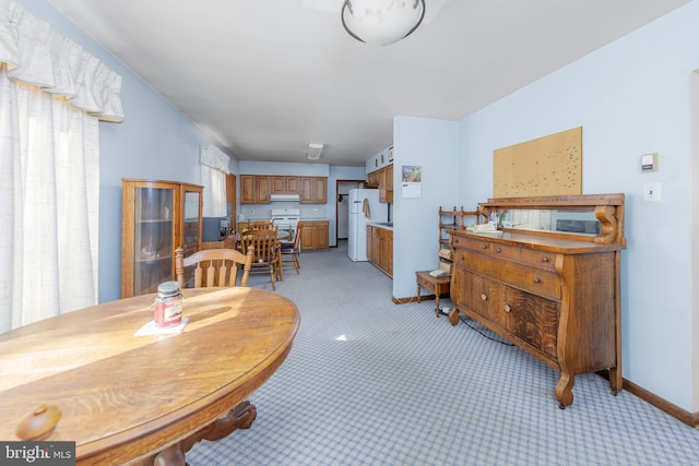 dining area featuring light colored carpet