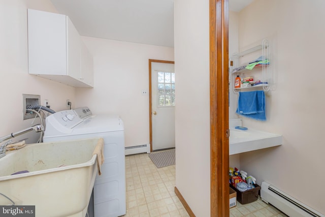 laundry room with baseboard heating, sink, washer and clothes dryer, and cabinets