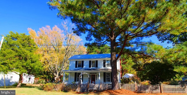 view of front of property with a porch and a fenced front yard