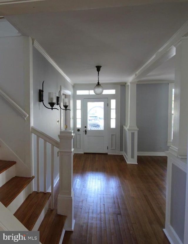 entryway featuring ornamental molding and dark hardwood / wood-style floors