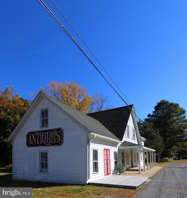 view of side of home with covered porch