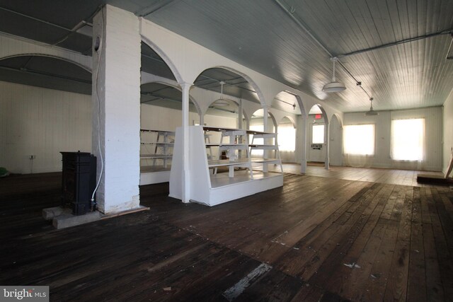 spare room with dark wood-type flooring and wooden walls