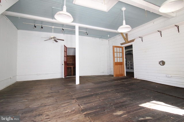 spare room featuring dark hardwood / wood-style floors, a high ceiling, a skylight, and ceiling fan