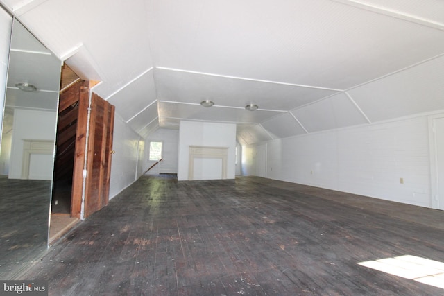 additional living space with lofted ceiling and dark wood-type flooring