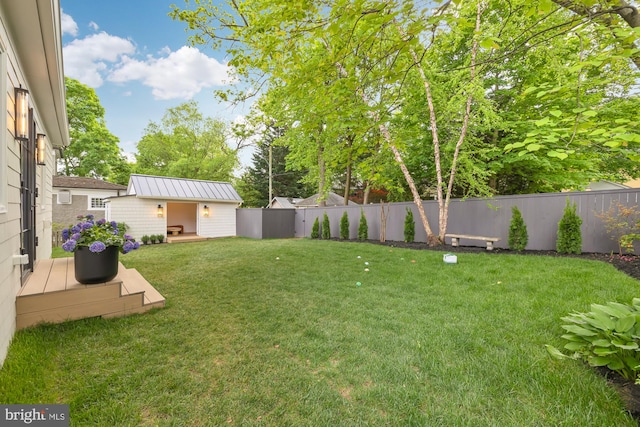 view of yard with a deck and a storage unit