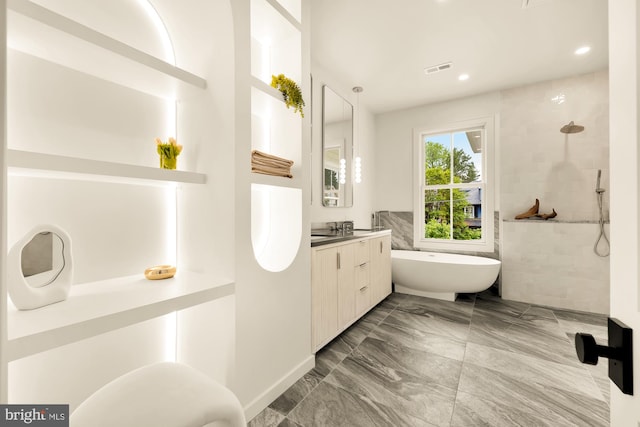 bathroom featuring vanity and shower with separate bathtub