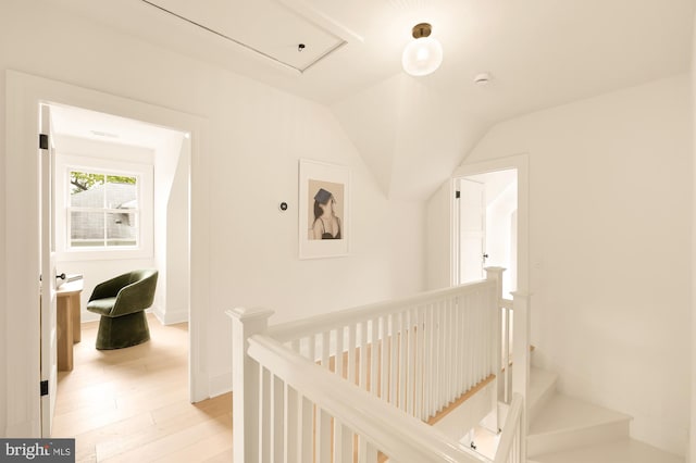 hallway featuring light wood-type flooring and lofted ceiling