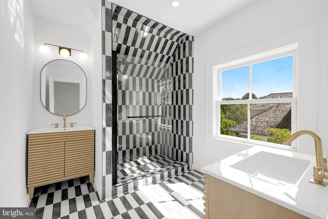 bathroom featuring a tile shower and vanity