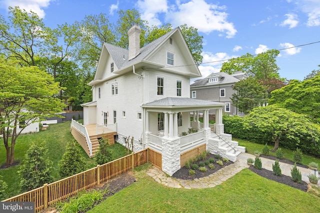 back of property with a porch