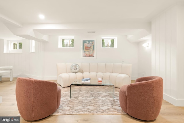 living room with a wealth of natural light and light hardwood / wood-style floors