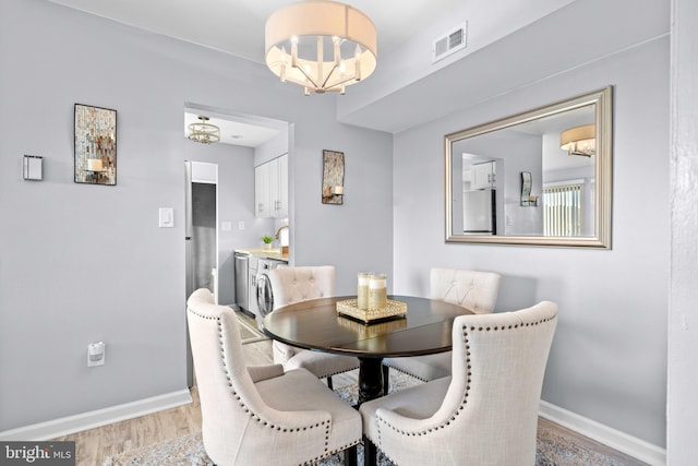 dining space with an inviting chandelier and hardwood / wood-style floors