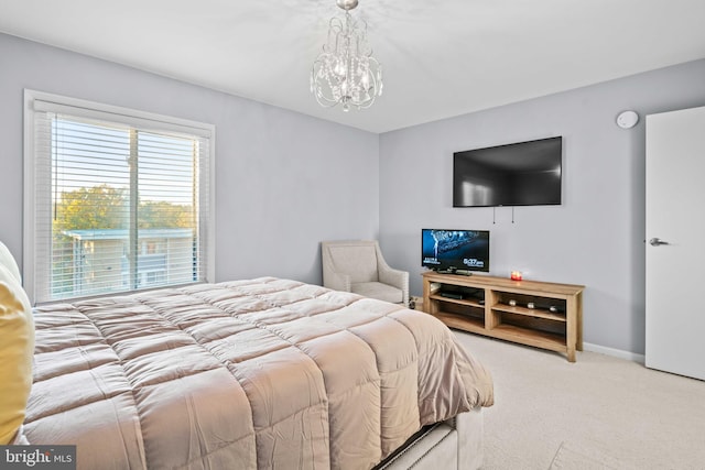 carpeted bedroom with a notable chandelier