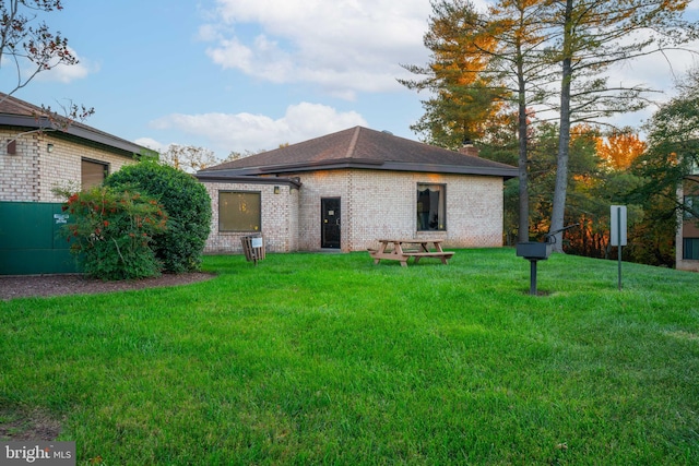 rear view of property with a yard