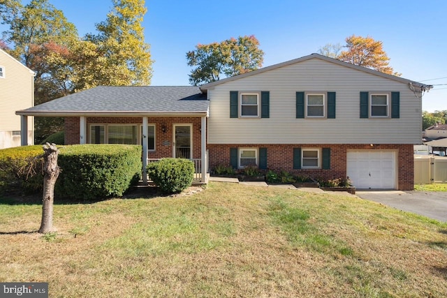 tri-level home featuring a front yard and a garage