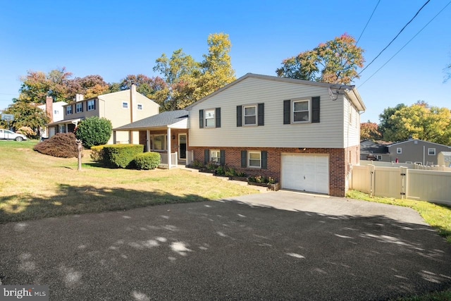 tri-level home with a front lawn and a garage