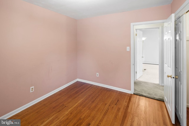 empty room with hardwood / wood-style flooring