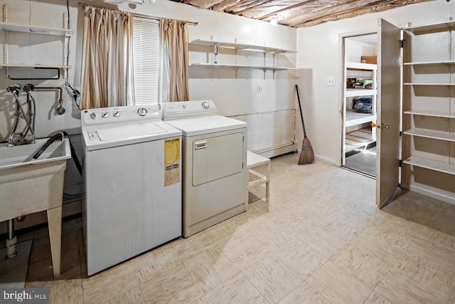 washroom with washer and dryer and a baseboard radiator