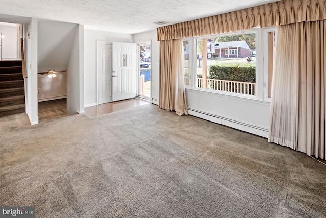 carpeted empty room featuring a baseboard radiator, a textured ceiling, and lofted ceiling