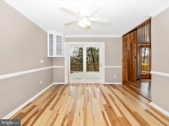 spare room with hardwood / wood-style floors, ceiling fan, and ornamental molding