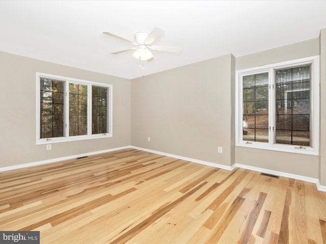 empty room featuring light hardwood / wood-style flooring and ceiling fan