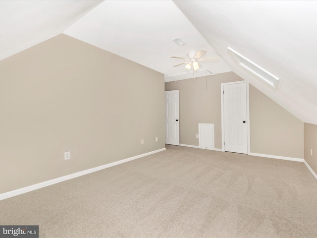 additional living space featuring ceiling fan, lofted ceiling, and light carpet