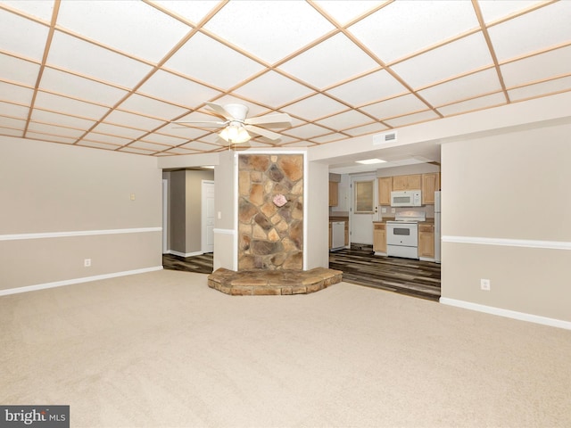 unfurnished living room featuring ceiling fan and carpet