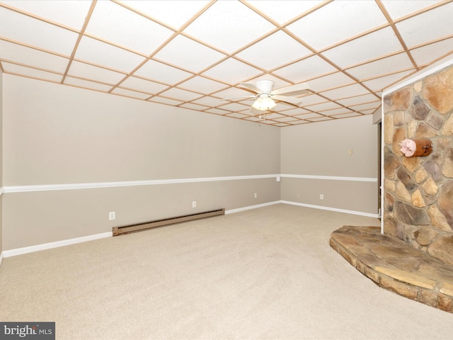 unfurnished living room featuring carpet flooring, baseboard heating, and ceiling fan