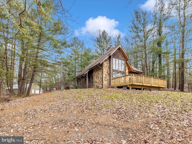 view of home's exterior featuring a wooden deck