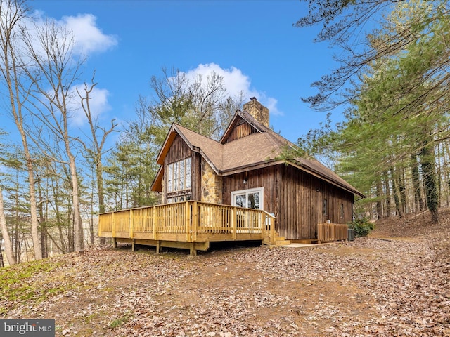 back of property featuring a wooden deck