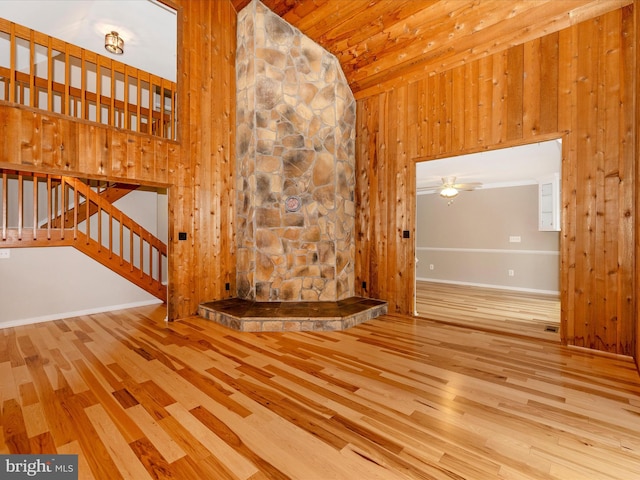 unfurnished living room with light wood-type flooring, high vaulted ceiling, and ceiling fan