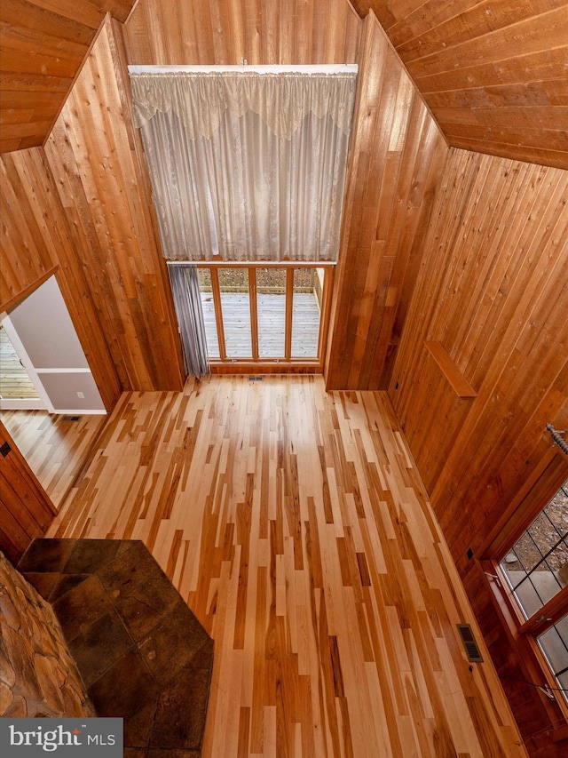 additional living space featuring wood walls and wood ceiling