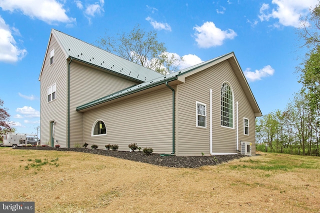 view of side of property with a lawn