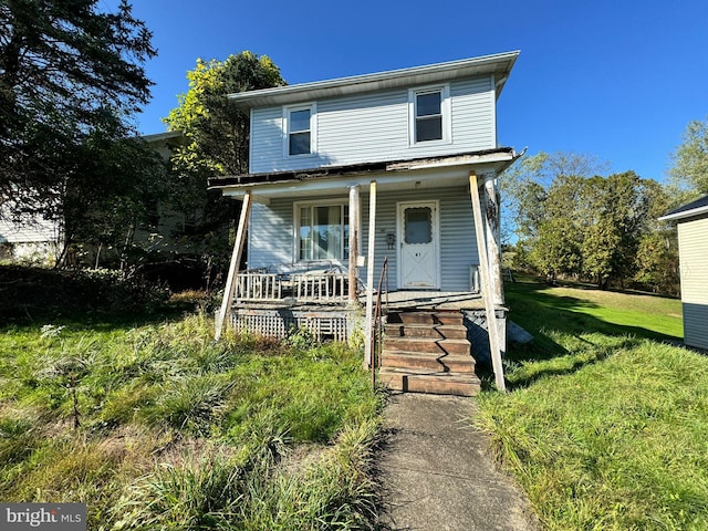 view of front facade with covered porch and a front yard