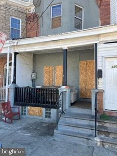 view of exterior entry featuring a porch