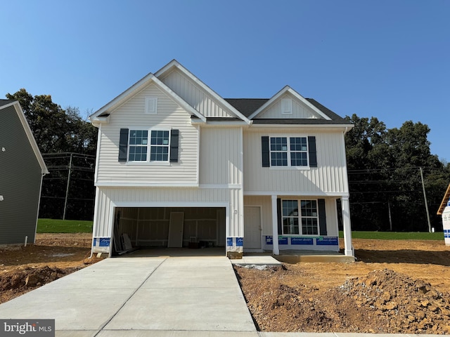 view of front of property featuring a porch and a garage