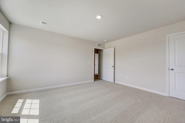 spare room with light colored carpet