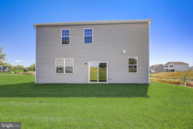 rear view of house with a yard