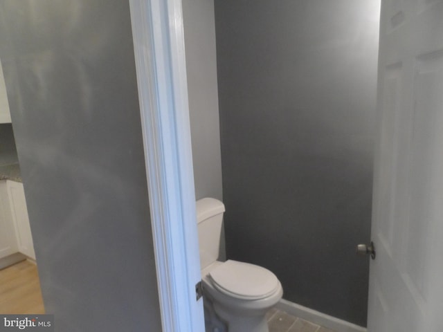 bathroom featuring hardwood / wood-style flooring and toilet