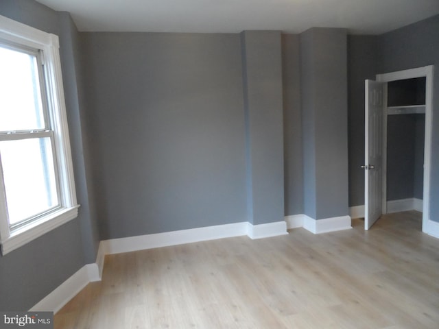 unfurnished room featuring light hardwood / wood-style flooring and plenty of natural light