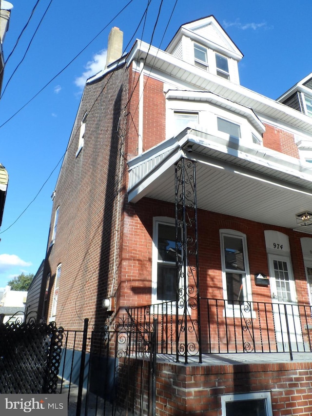 view of side of home with covered porch