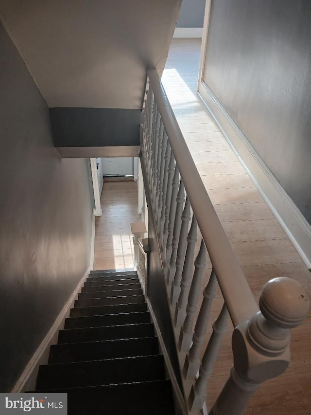 stairway featuring hardwood / wood-style flooring