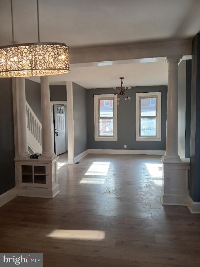 unfurnished living room featuring hardwood / wood-style floors and a notable chandelier