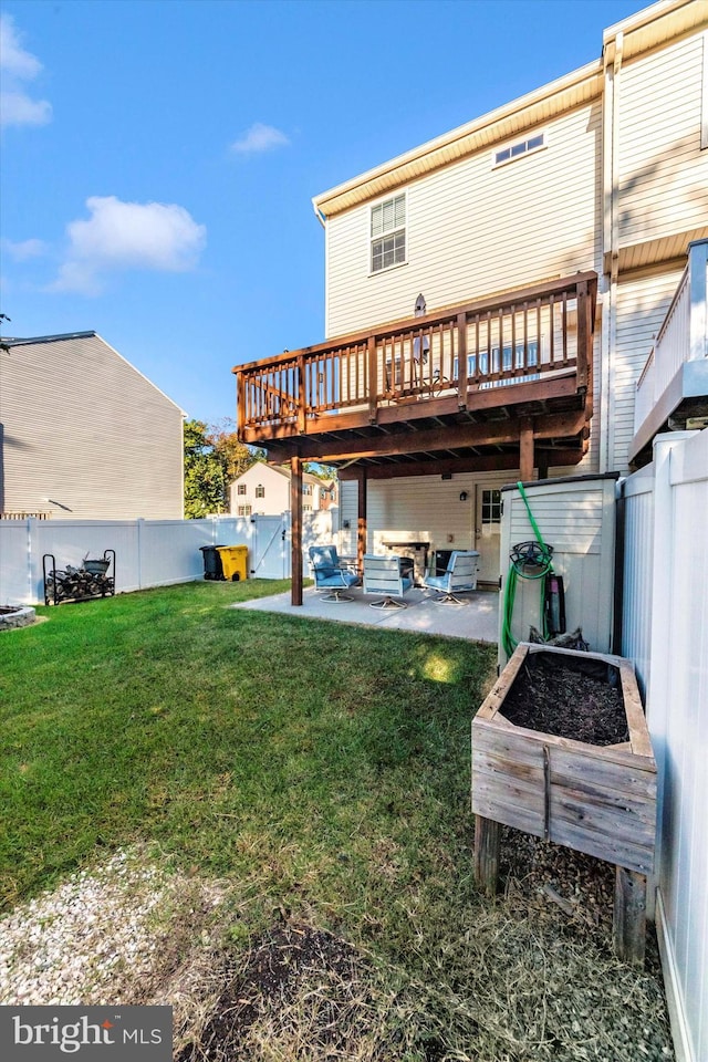 rear view of property featuring a wooden deck, a patio, and a lawn