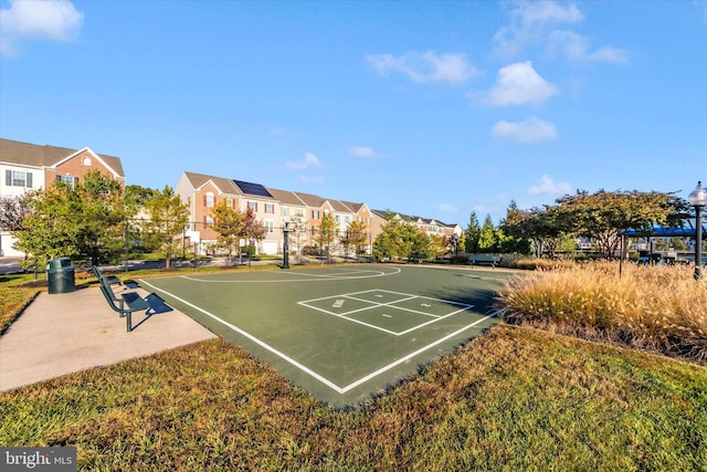 view of home's community with basketball hoop